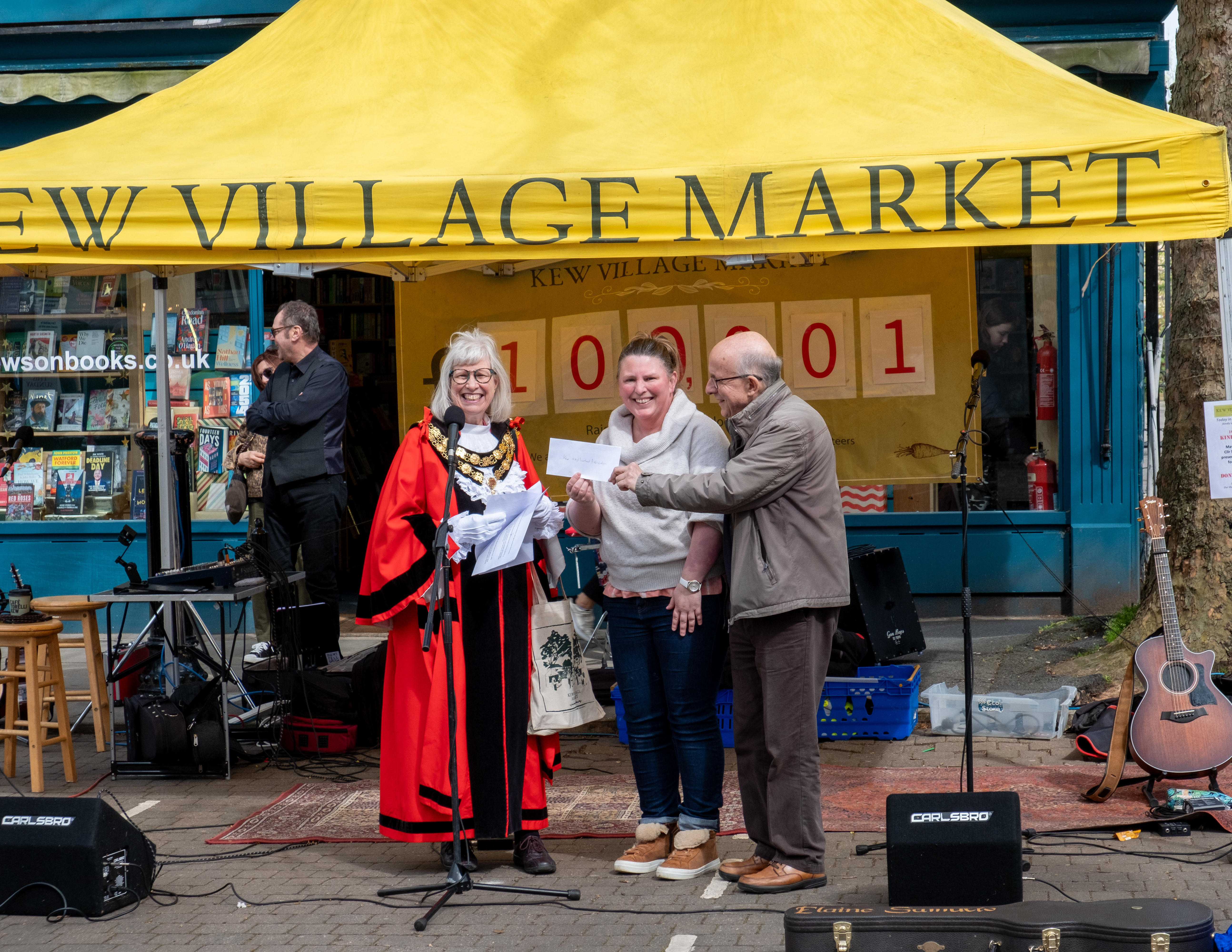 Our trustees being handed the cheque by the mayor in her ceremonial regalia