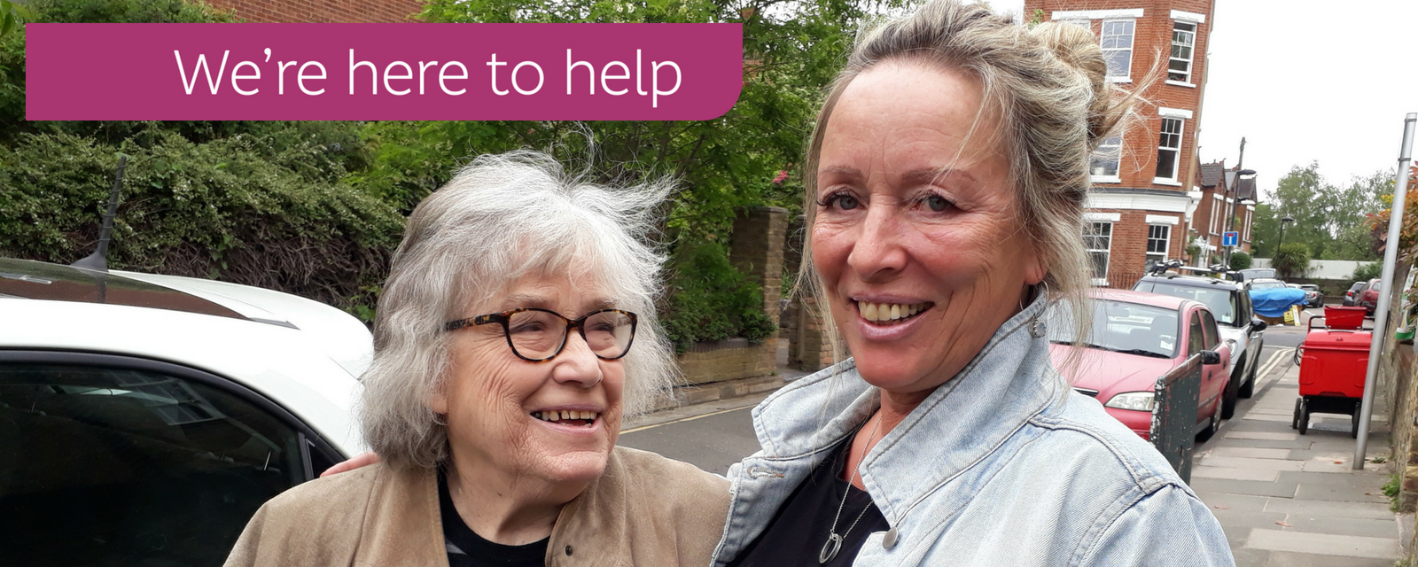 Volunteer and elderly lady next to a car